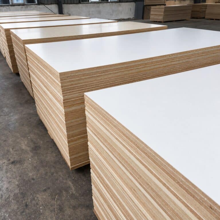 Stacks of melamine-faced plywood panels in a Chinese factory