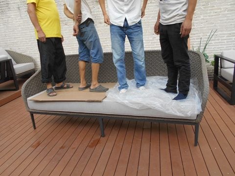 Load test on an outdoor sofa during a furniture inspection in China